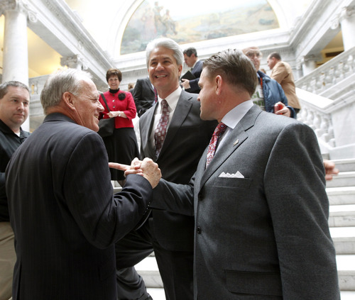 Al Hartmann  |  The Salt Lake Tribune
Stephen Nadauld, President of Dixie State College, left, joins hands in solidarity with Southern Utah State University President Michael Benson on the steps of the Capitol rotunda after passage of HB61 changing Dixie State College to university status. Steven Caplin, Chair of Dixie State College Board of Trustees, center,  joins them in celebration.